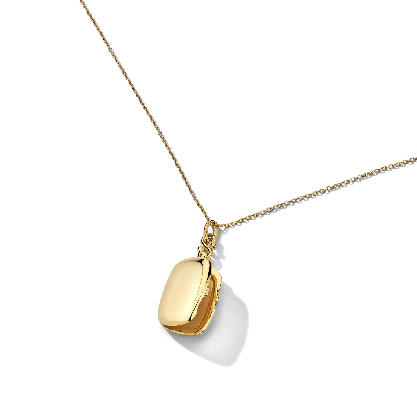 Monica Rich Kosan yellow gold locket on a white background.
