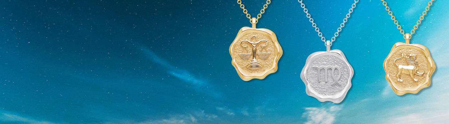 Birks Essentials Zodiac Libra, Virgo & Leo pendants in yellow gold and silver on a starry background.