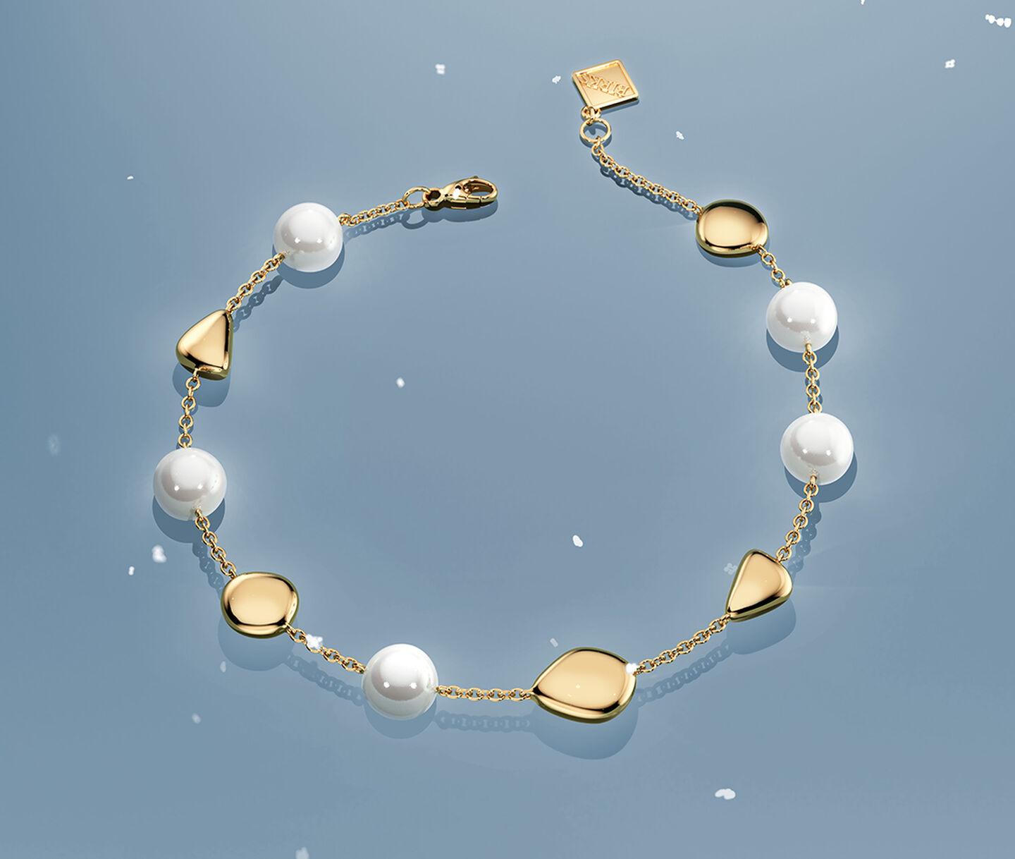 Birks splash white gold ring on a blue snowy background.