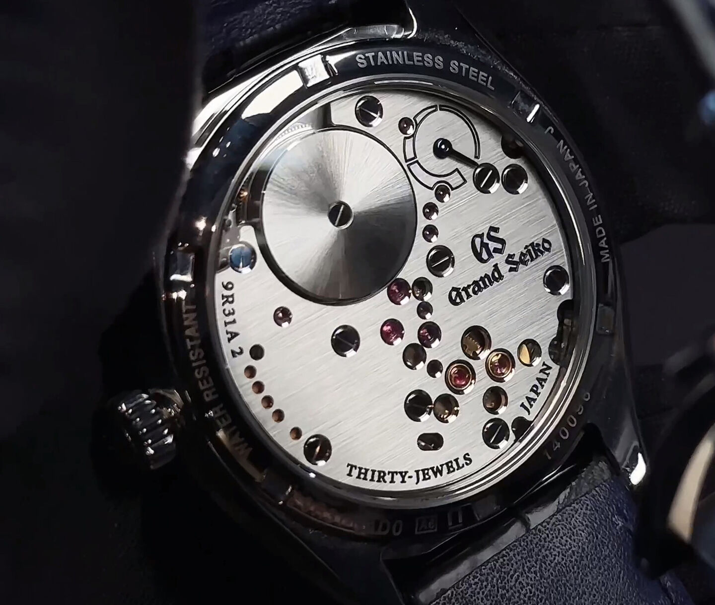 Grand Seiko watch movements on a black background.