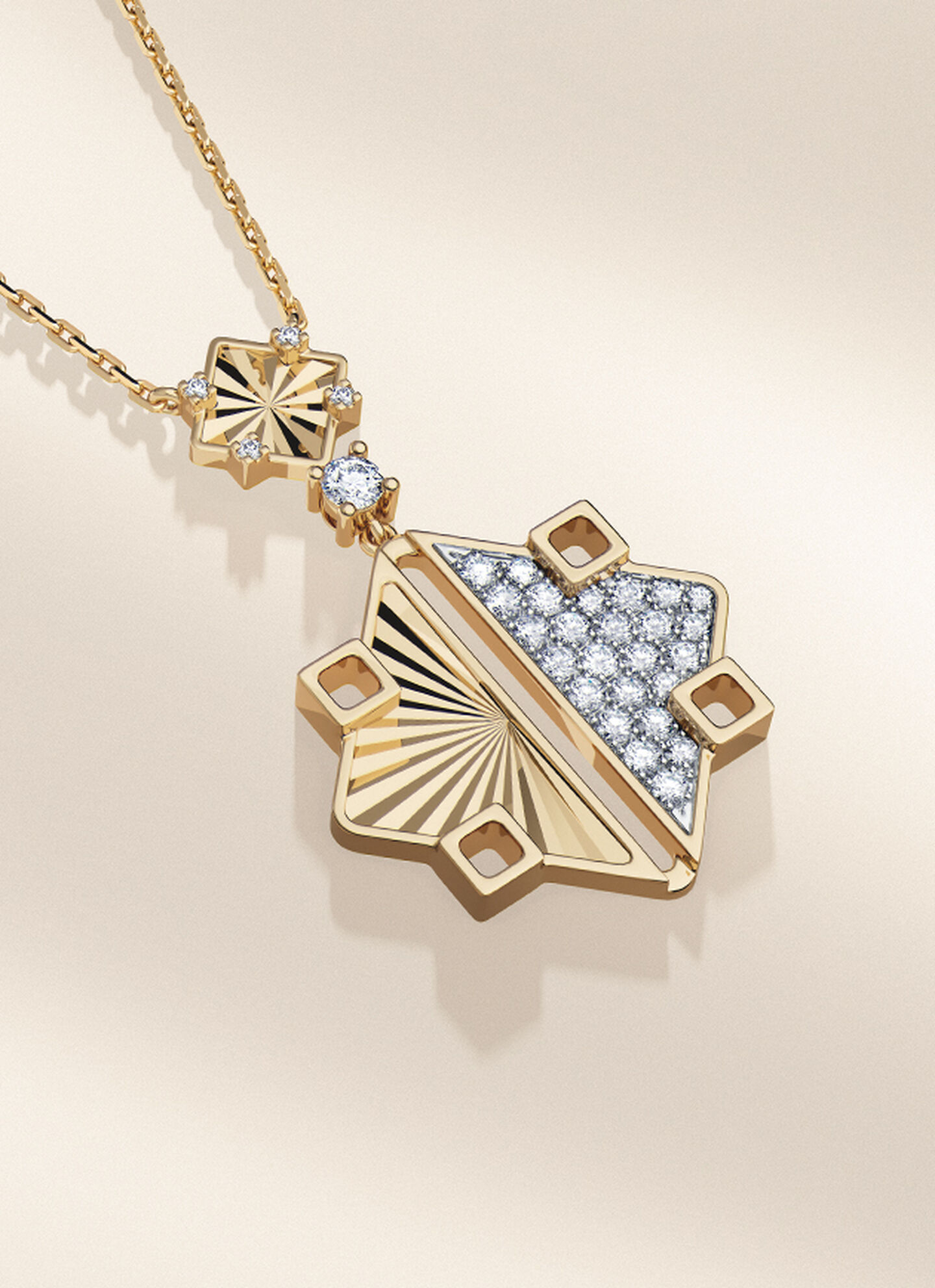 Birks Muse gold and diamond drop necklace on a grey background.