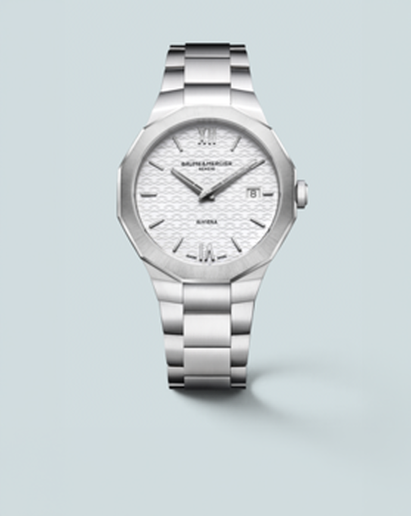 Baume & Mercier Riviera watch on a light blue background.