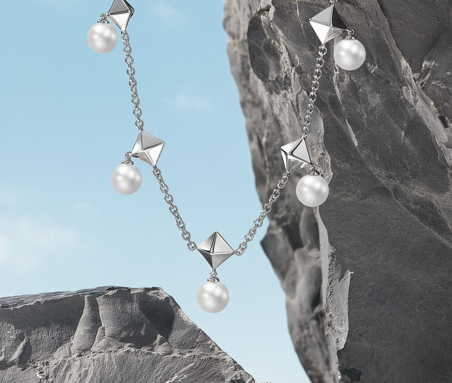 Birks Rock & Pearl silver and pearl necklace hanging off a rock.