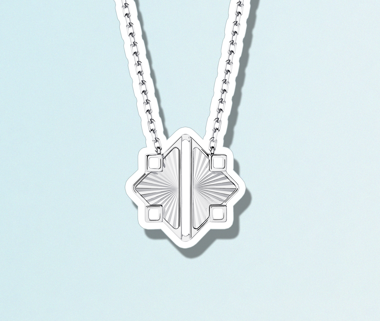 a white gold pendant on a light blue background.