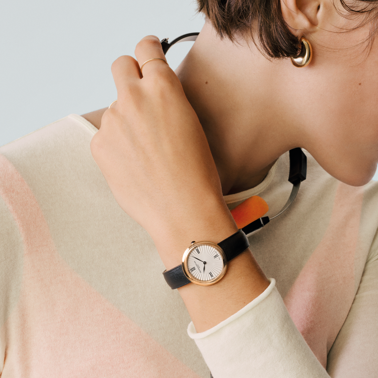 A woman wearing a Baume & Mercier Joia watch.