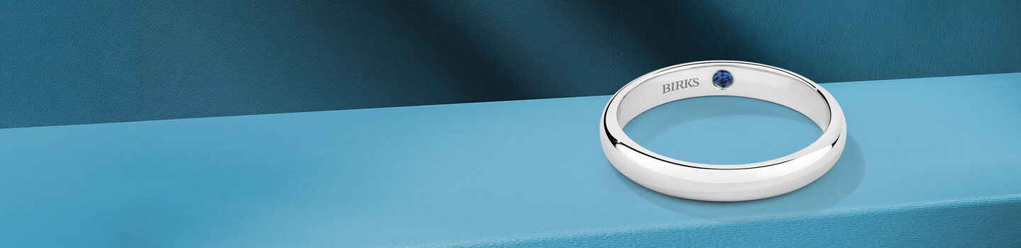 Birks Blue and diamond wedding bands on a blueish background.