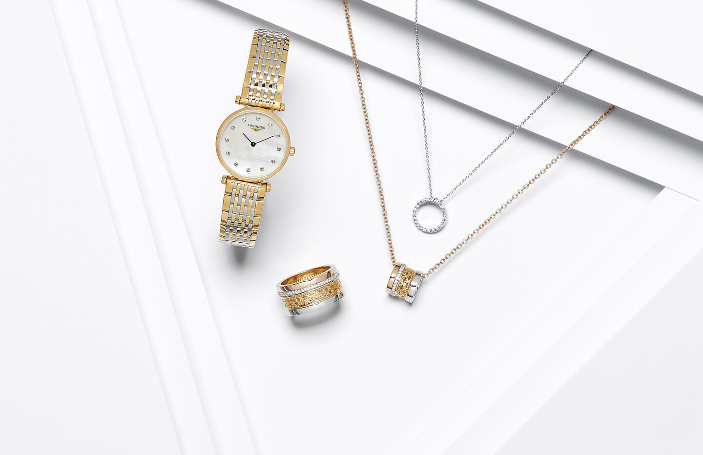A gold watch, tri-gold ring and necklace and a white gold diamond necklace