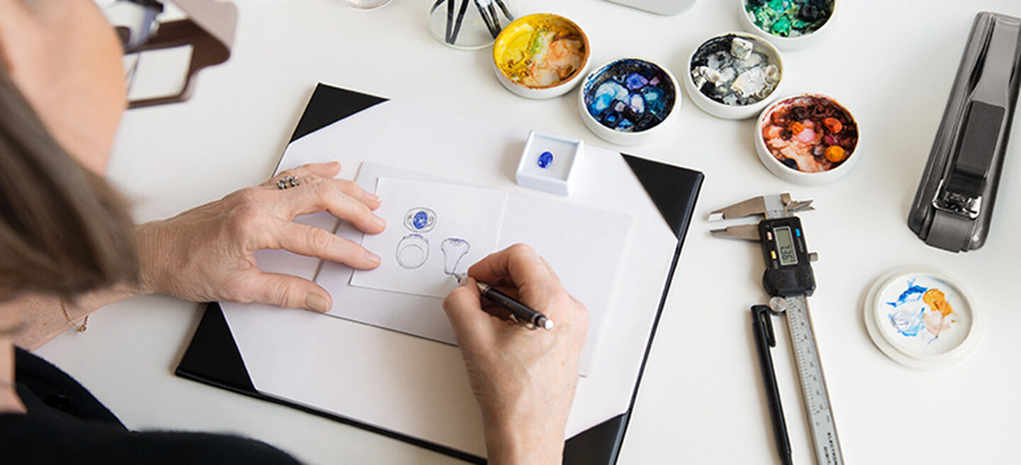An artist sketching a ring design