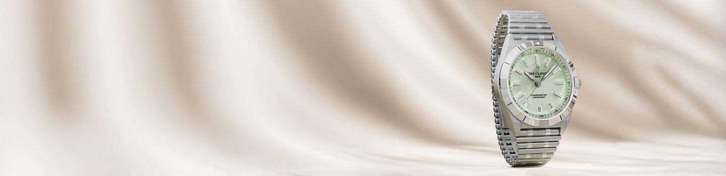 Women's Breitling watch on a beige background.