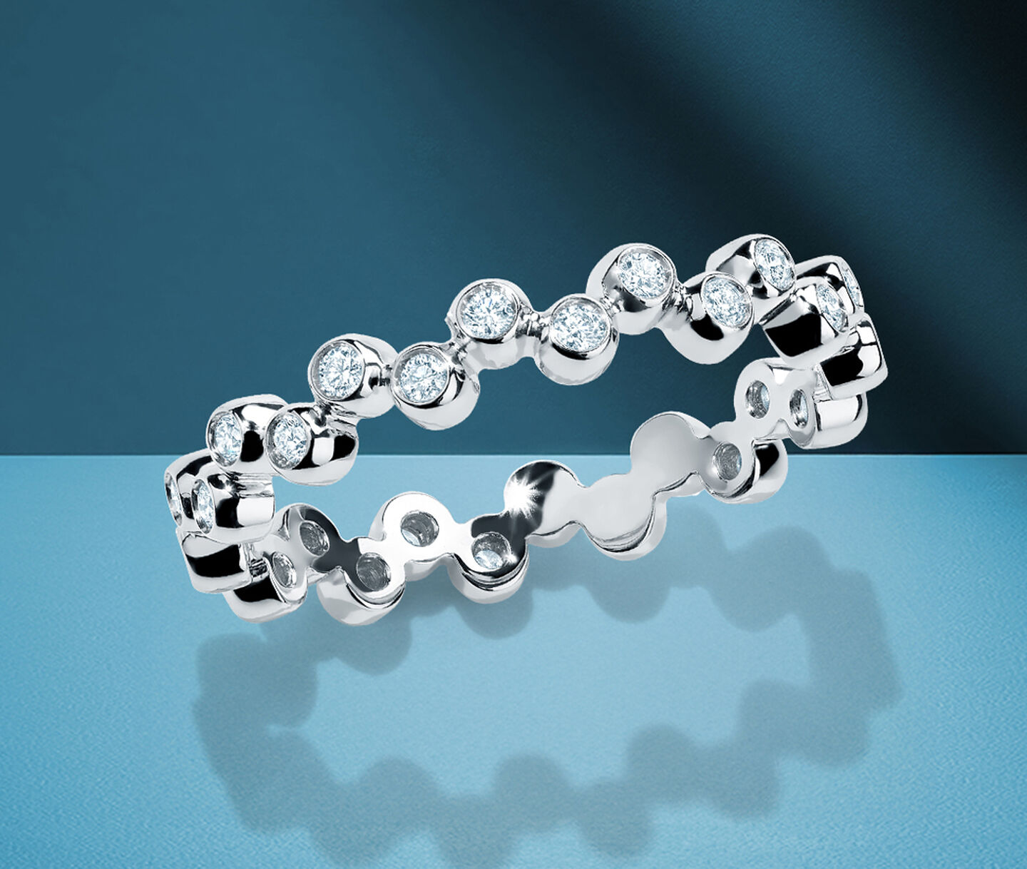Birks Iconic diamond ring on a blue background.