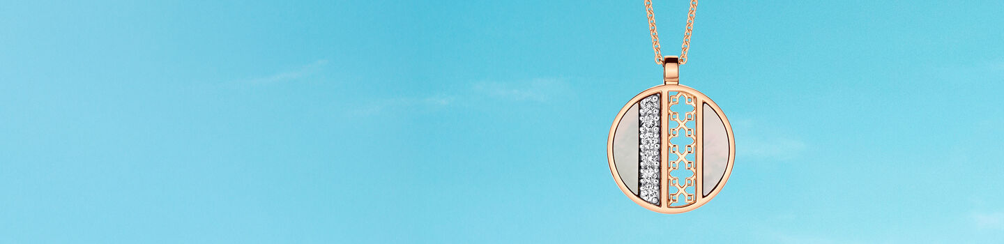 Birks Dare to Dream mother-of-pearl necklace on a blue background