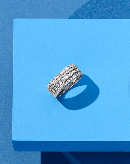 Birks Splash diamond ring on a blue background.