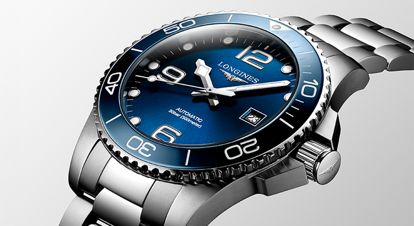 Longines conquest watch on a greige background.