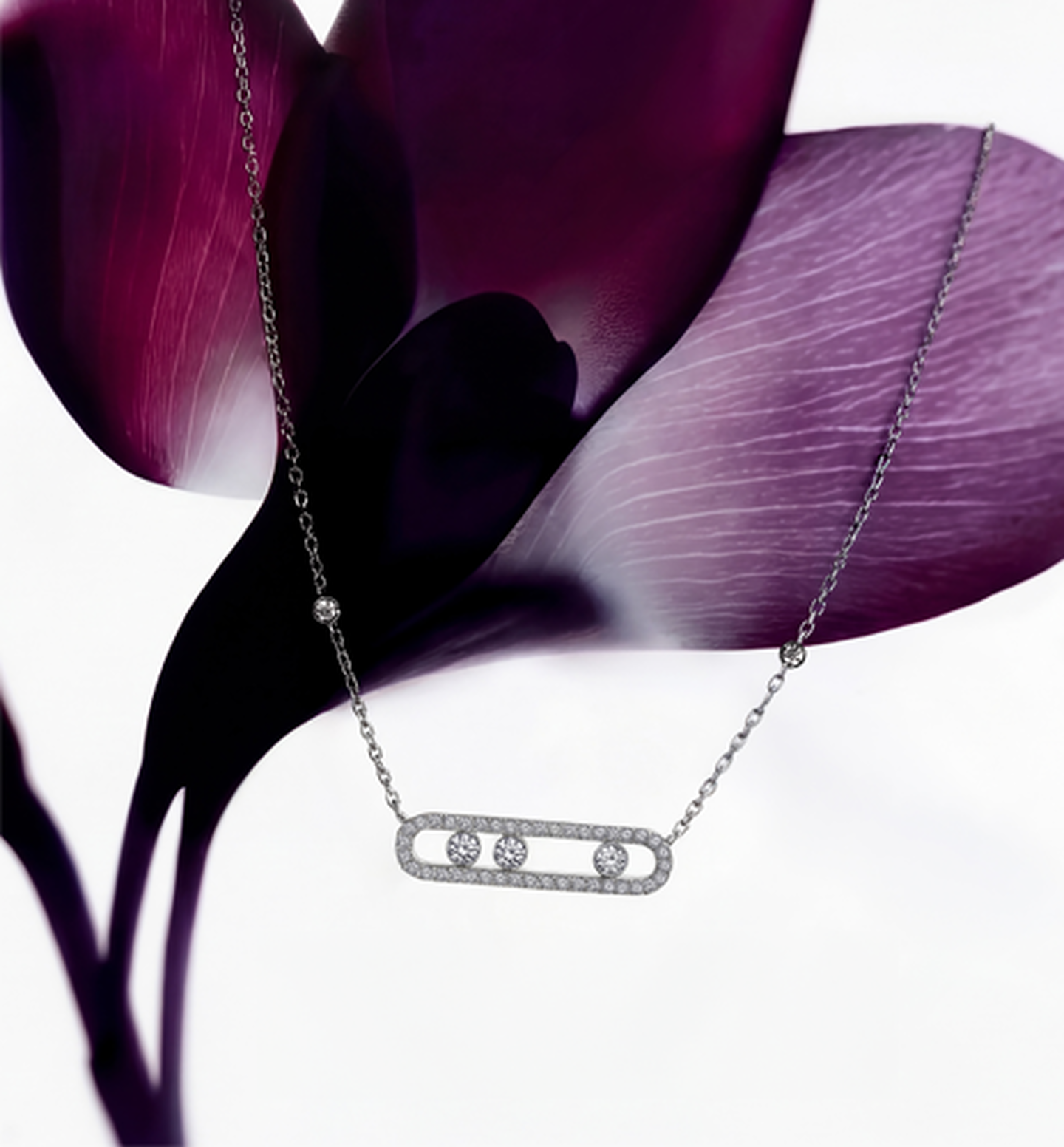 Messika diamond necklace with a floral background.