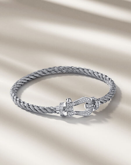 FRED Force 10 bracelet on a beige background.