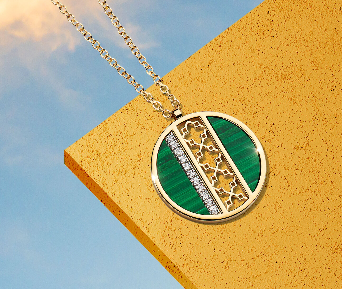 Birks Dare to Dream Malachite and Diamond Pendant on a gold background.