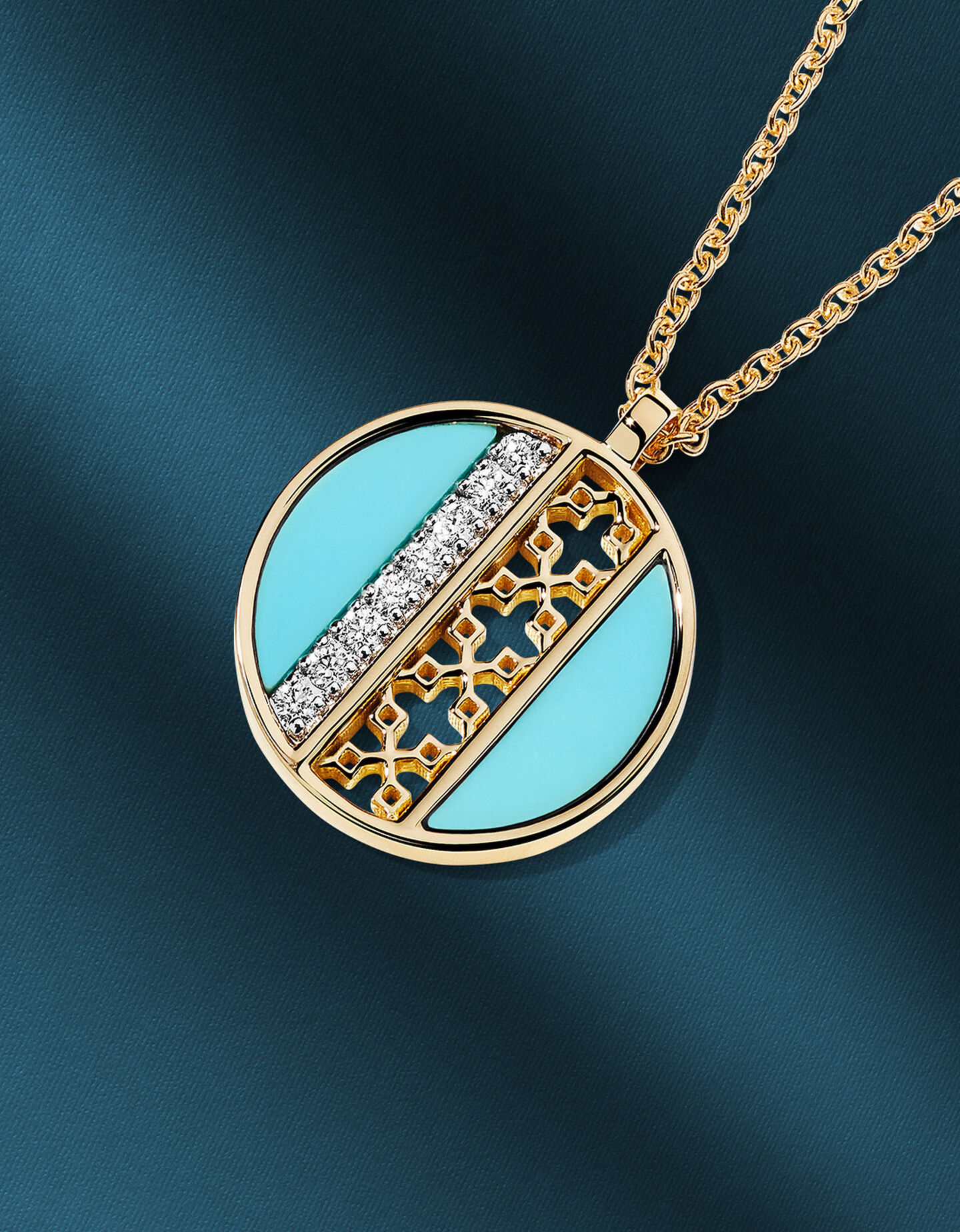 Birks Dare to Dream turquoise and diamond pendant on a dark blue background.