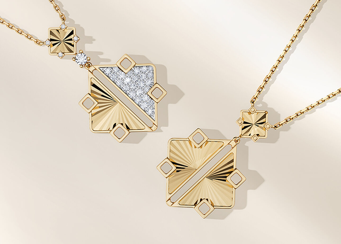 Birks Muse yellow gold drop necklaces on a beige background.