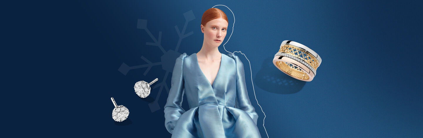 Model in a blue dress between a Tri-gold ring and a pair of diamond stud earrings