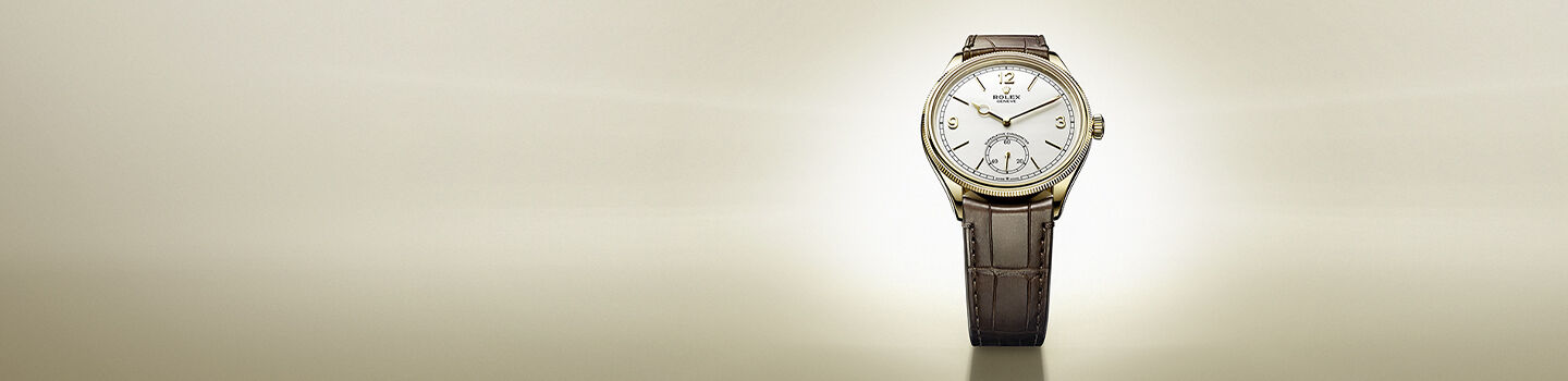Rolex 1908 M52508-0006 watch on a beige background.