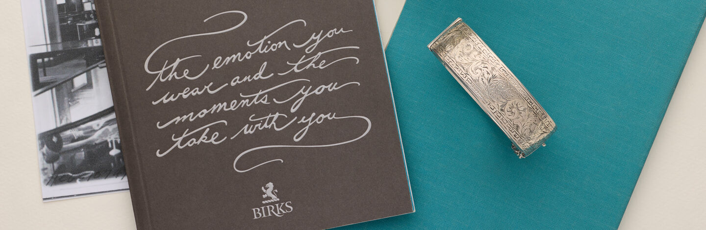 Engraved Birks ring beside archival keepsakes, celebrating meaningful moments and family stories