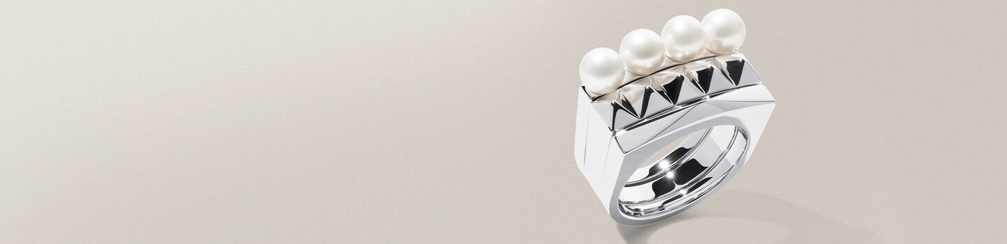 Birks Rock & Pearl silver ring on a greyish-beige background