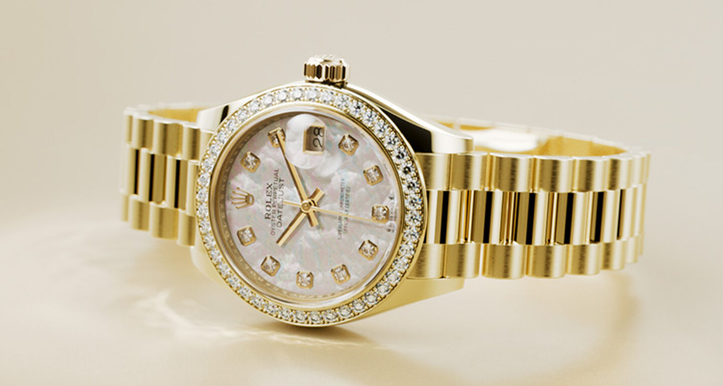 Gold watch with a mother of pearl face