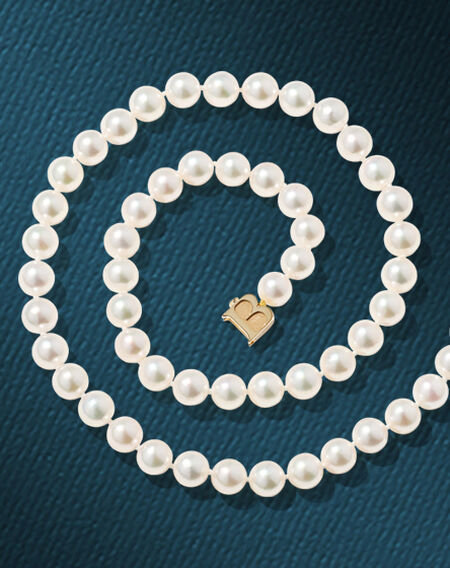 Birks Pearls necklace on a blue background.
