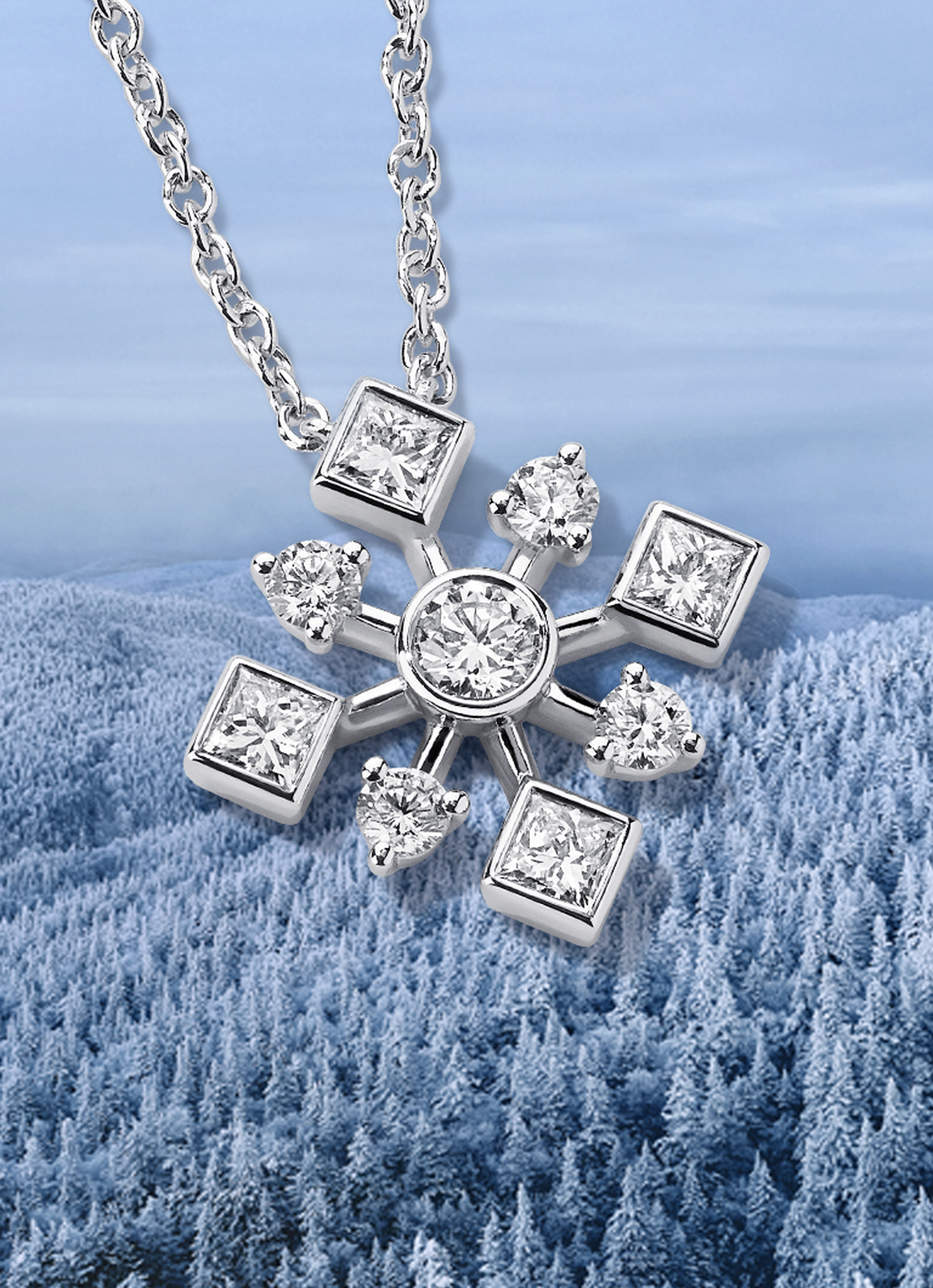 Birks Snowflake diamond pendant on a snowy background.