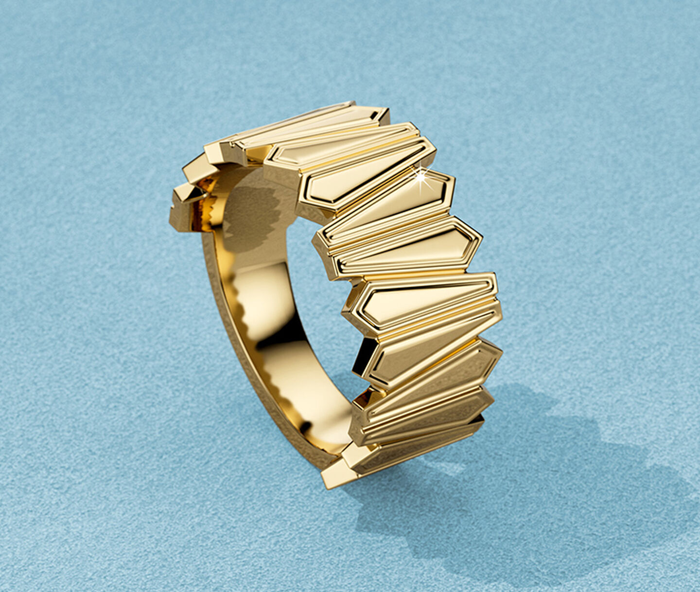 Birks Beekeeper yellow gold ring on a blue background.