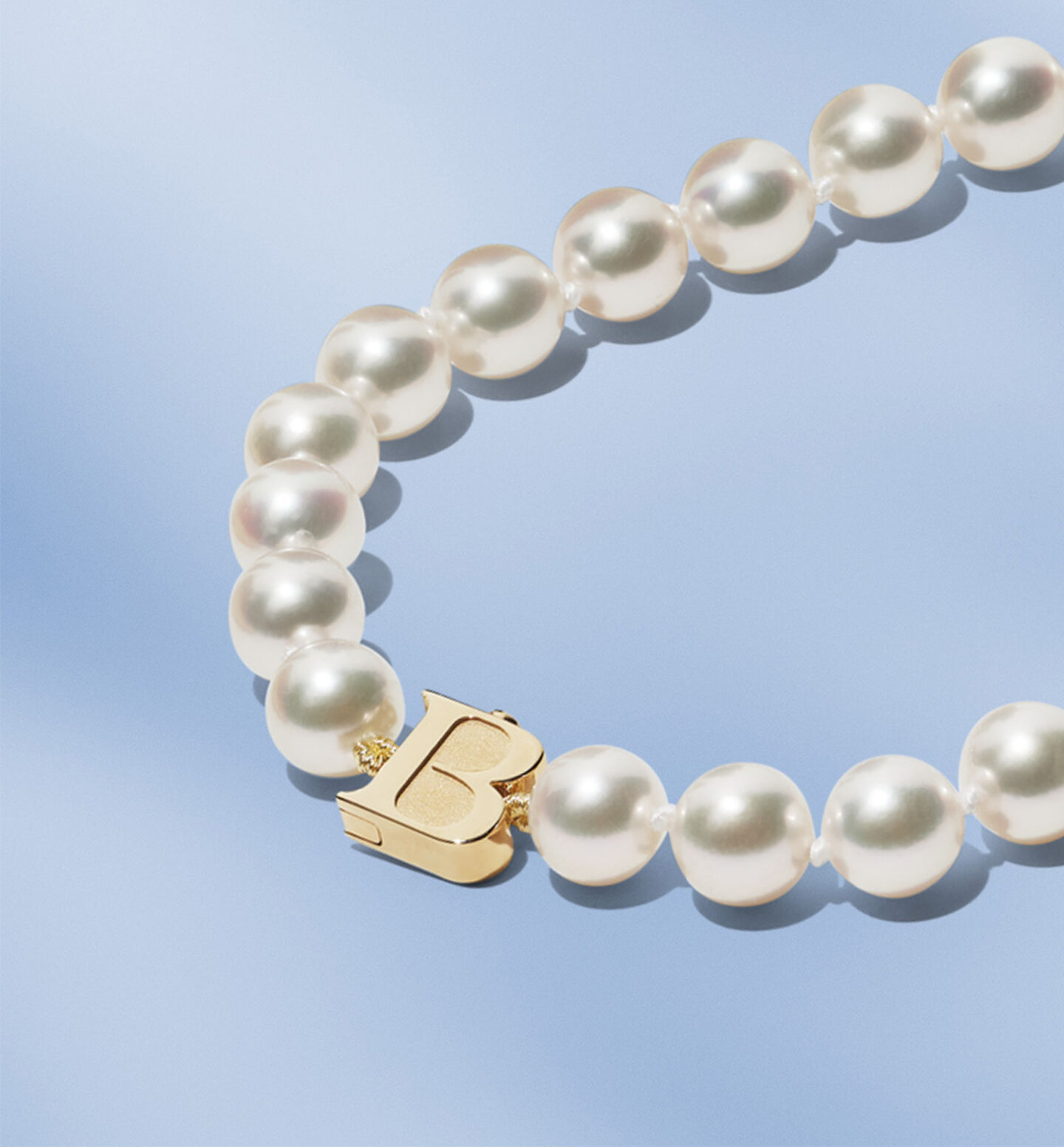 Birks Pearls Akoya Necklace on a blue background.