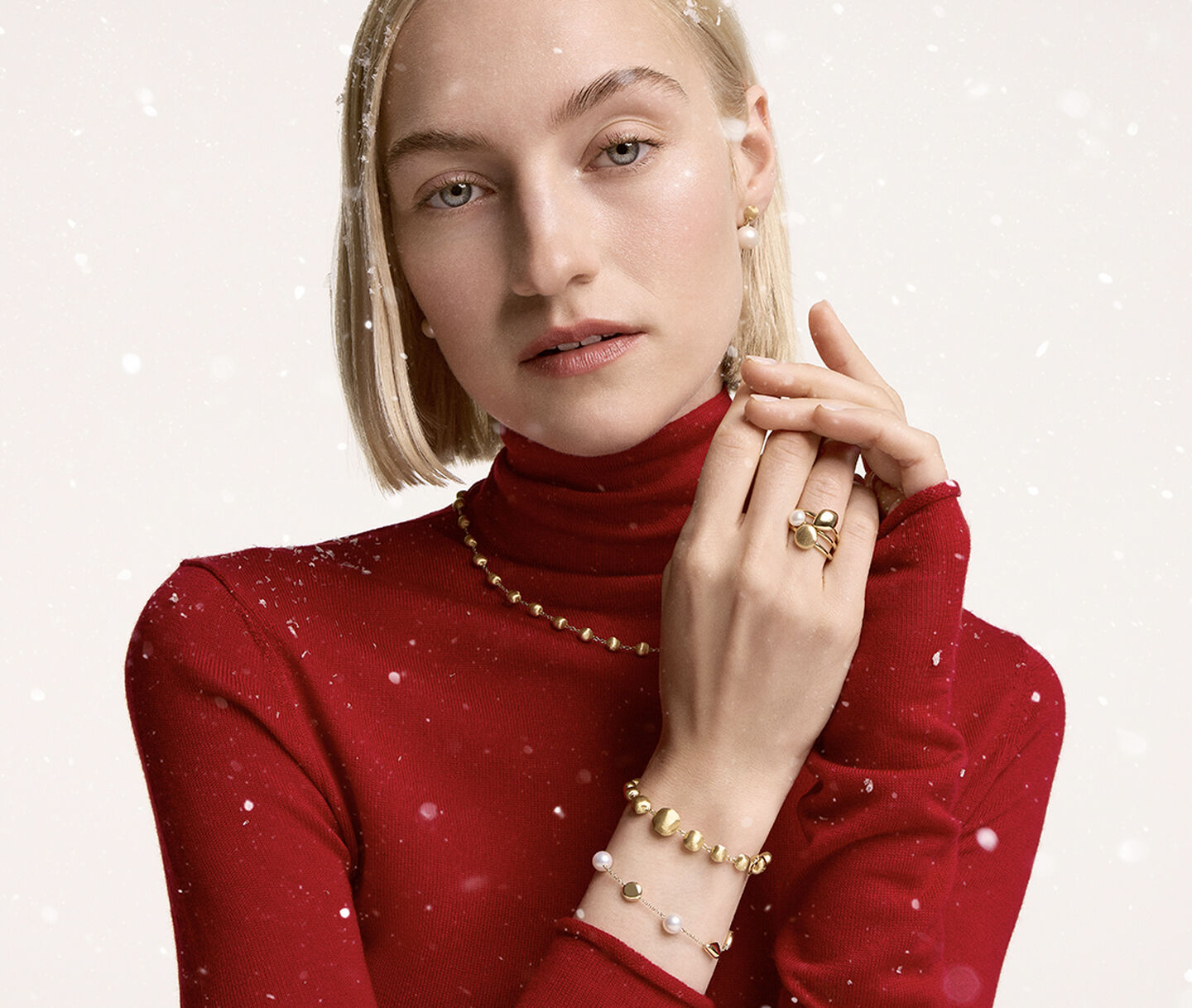 A woman wearing Birks Pearls and Marco Bicego necklace.