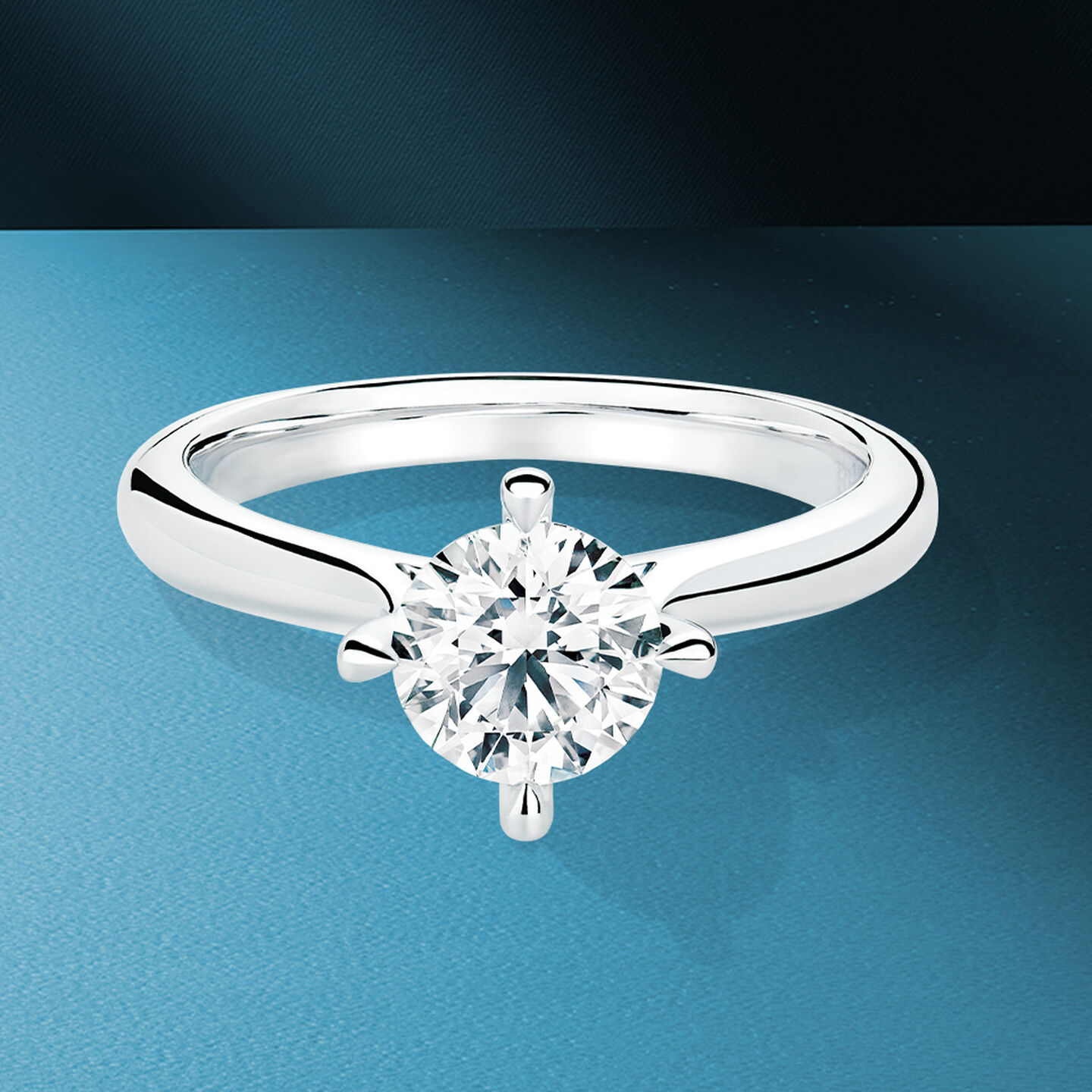 Birks Nordic Light engagement ring on a blue background.