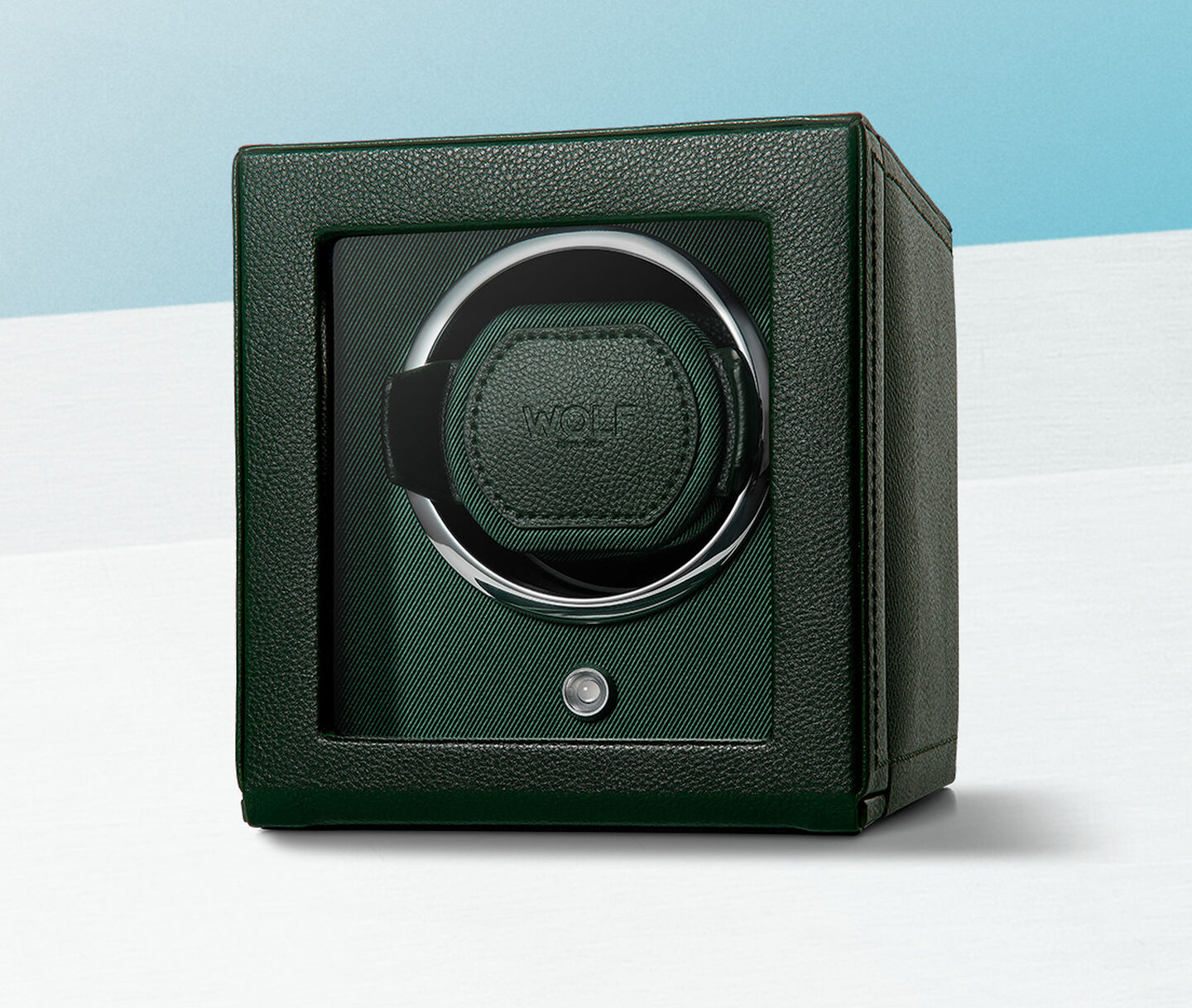 WOLF watch winder on a light blue background.