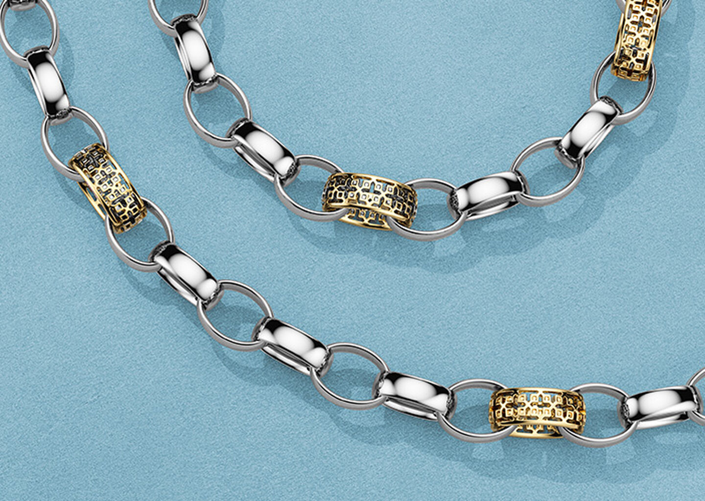 Birks Dare to Dream silver and gold link bracelet and necklace on a blue background.