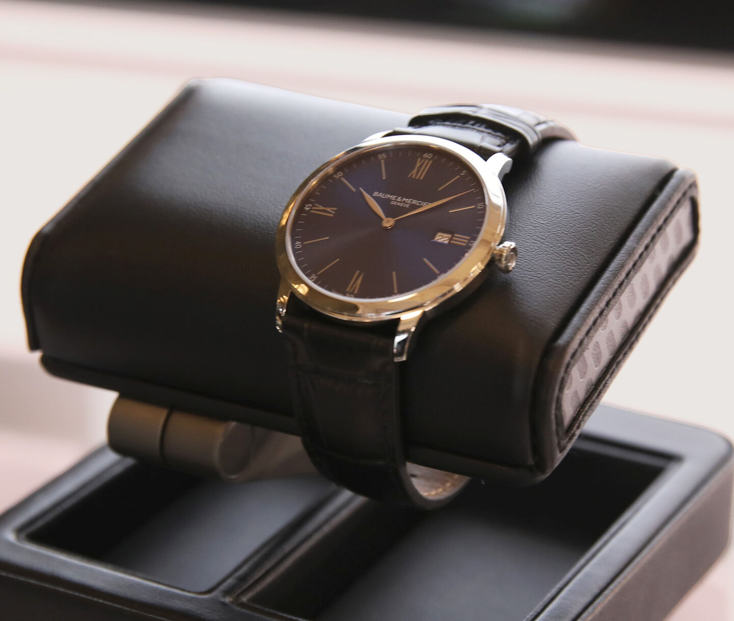 A watch on a WOLF watch stand.