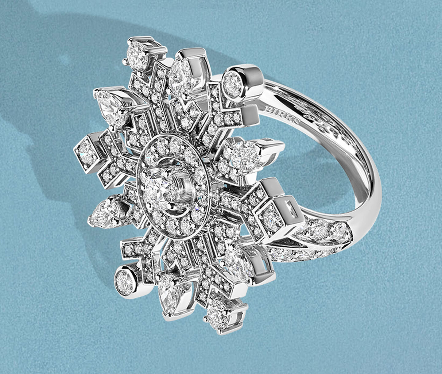 Birks Snowflake High Jewellery diamond ring on a blue background.