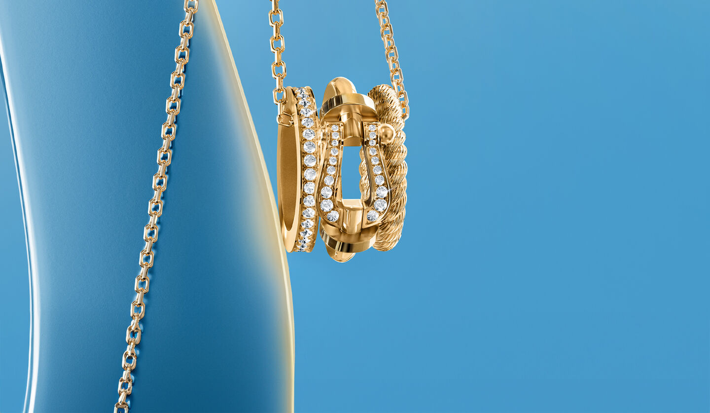 FRED Force 10 Rise necklace on a blue background.