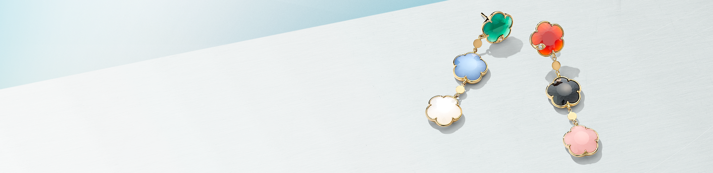 Pasquale Bruni Petit Joli earrings on blue background.