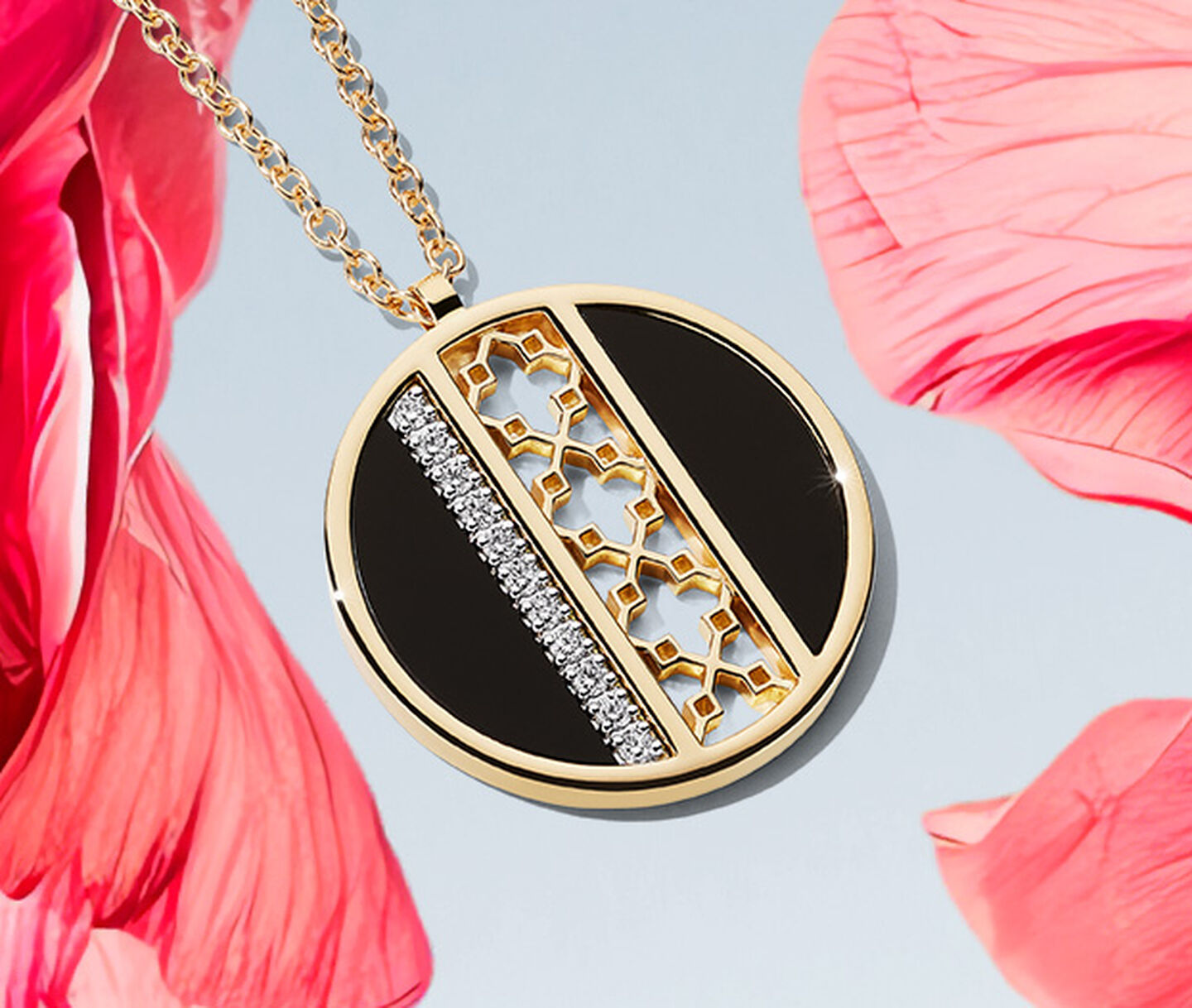 A Birks Dare to Dream onyx diamond medallion on a pink flower over a light sky blue background.