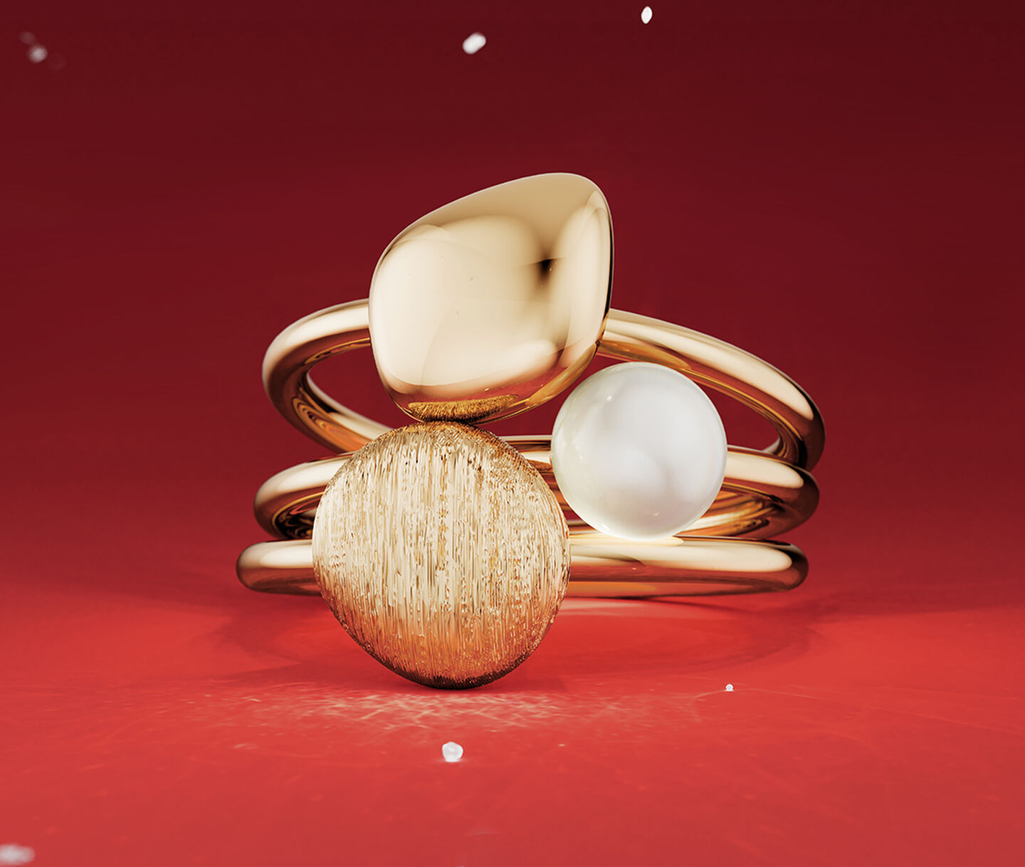 Birks pebble gold ring on a red holiday background.