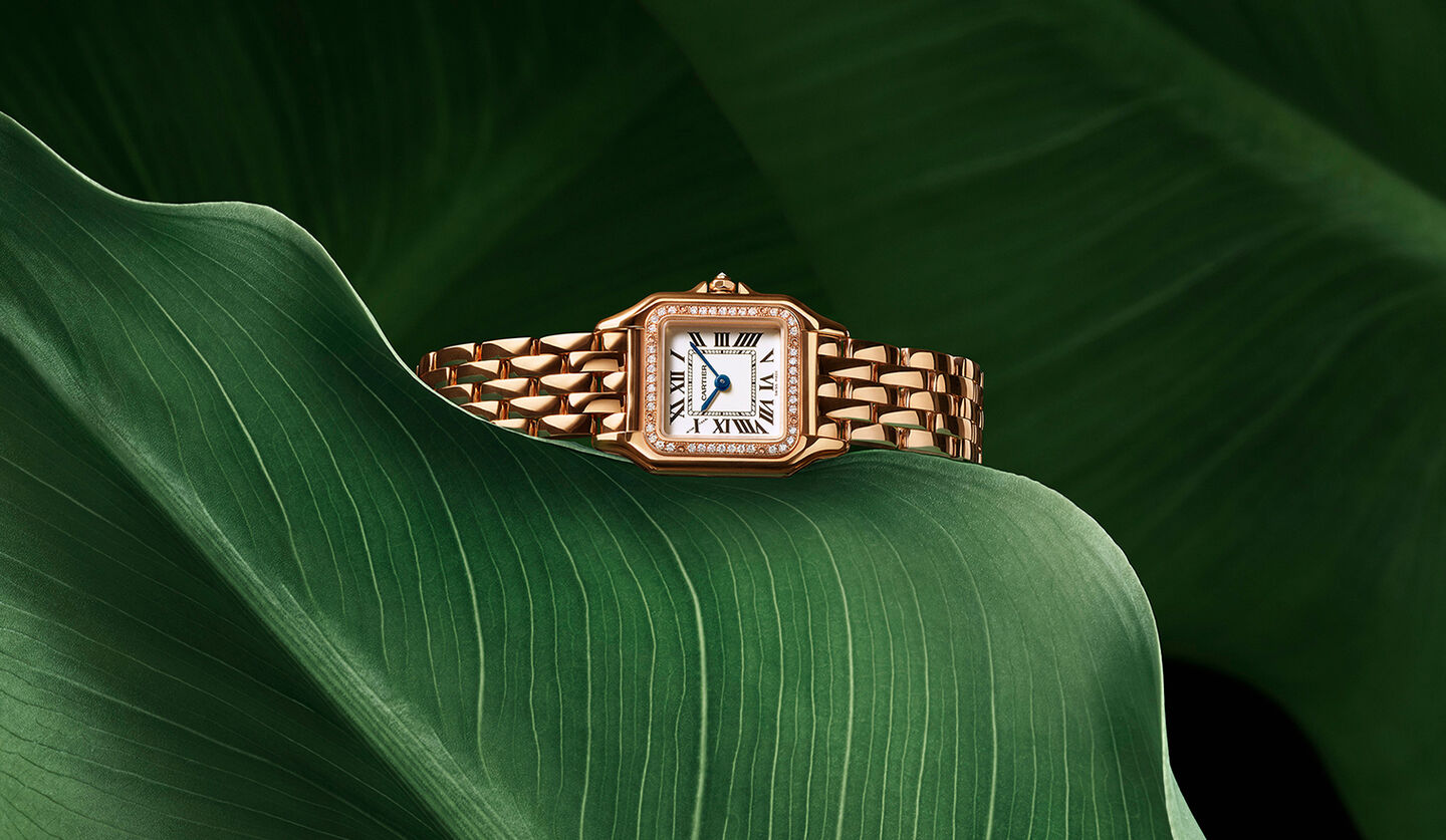 Panthère de Cartier watch on a leafy background.