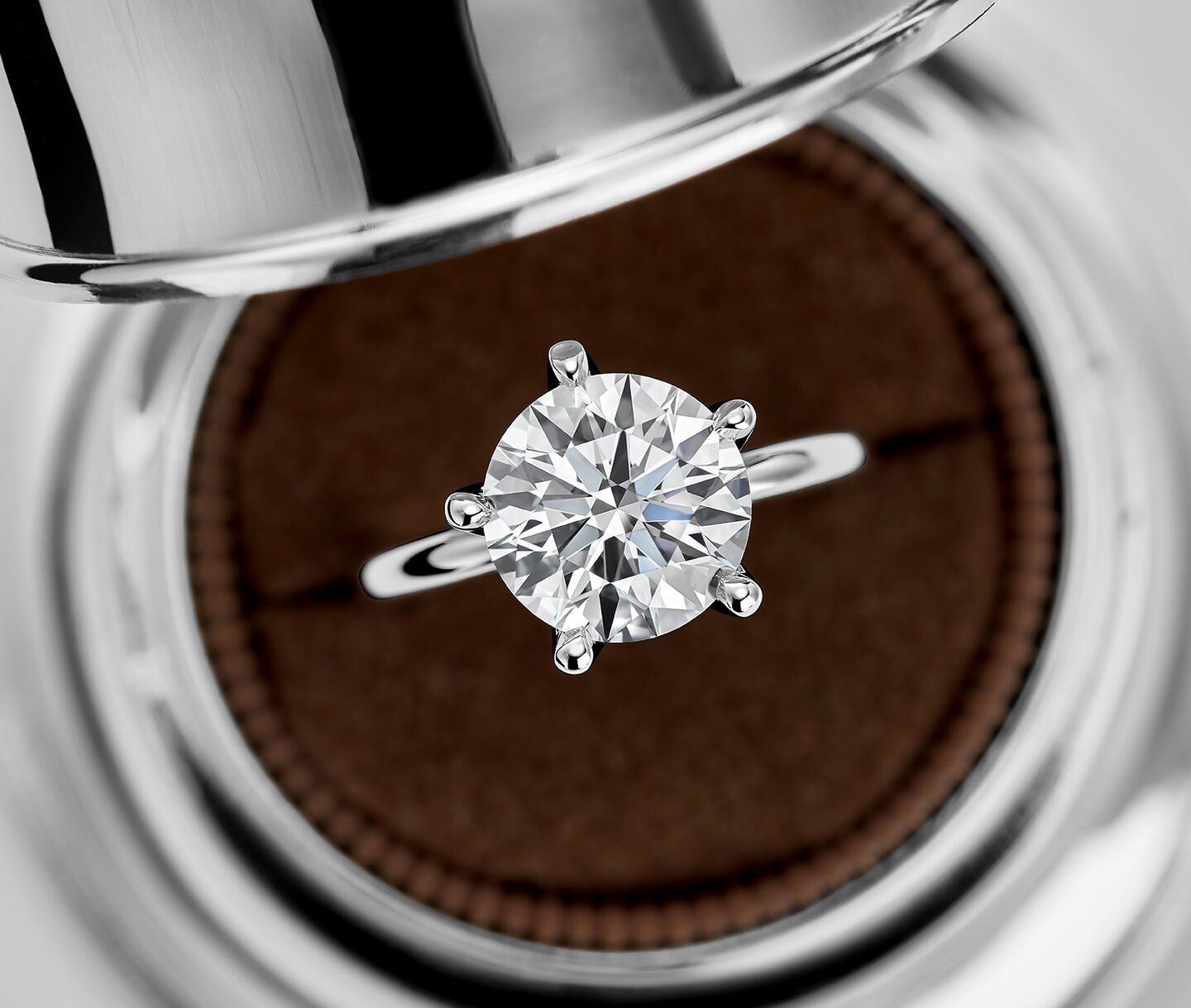 A Birks North Star Round Solitaire Diamond Engagement Ring in a Birks Bell Box.