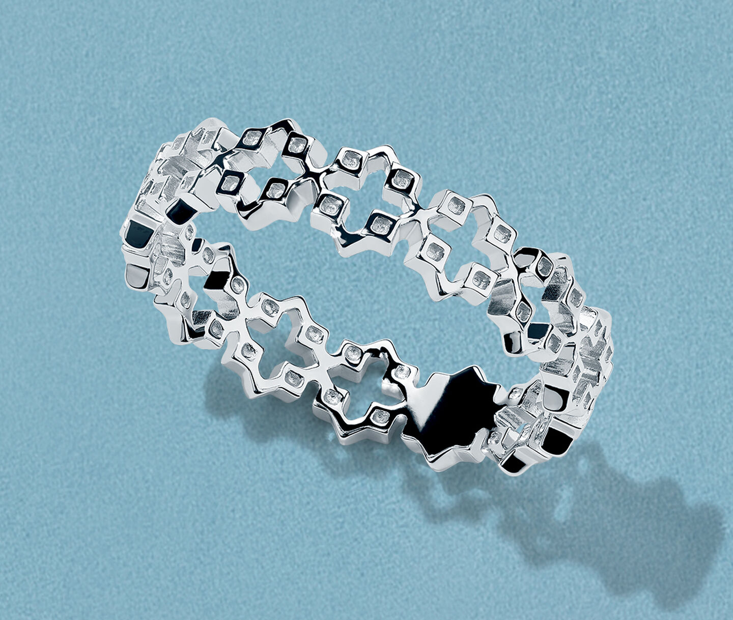 Birks Iconic silver Muse ring on a blue background.
