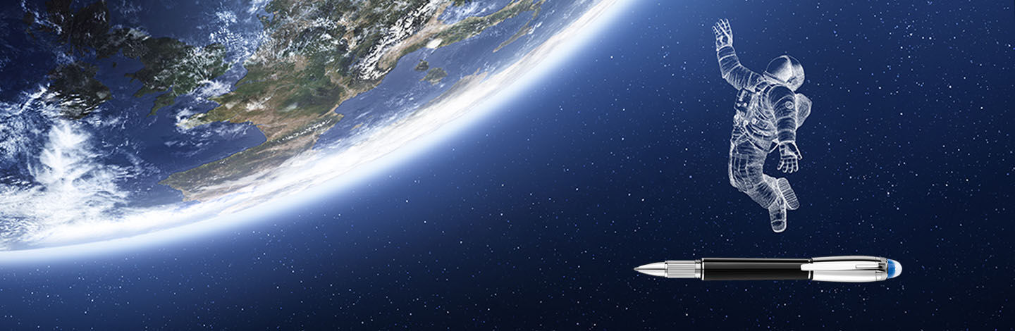Astronaut with a Montblanc pen at his feet reaching for the earth
