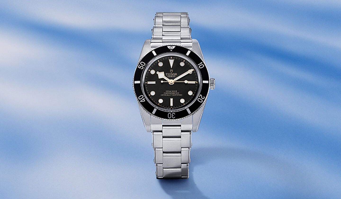 TUDOR Black Bay watch on a blue background.