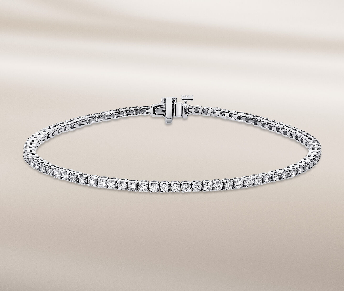 Birks Essentials diamond bracelet on a beige background.