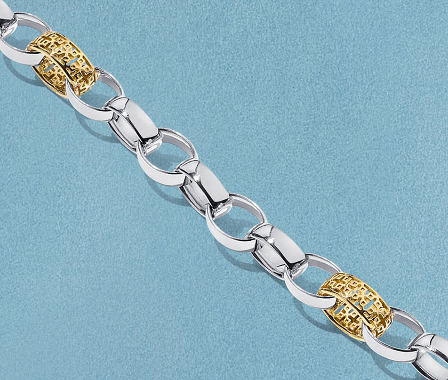 Birks Dare to Dream yellow gold and silver necklace on a blue background.