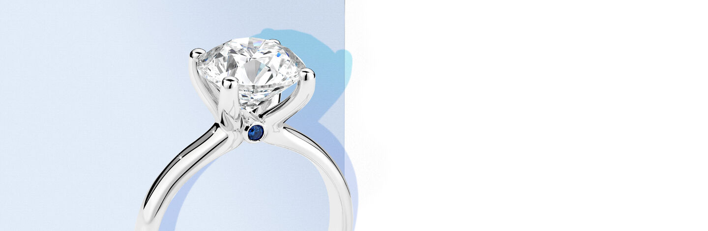White Gold Diamond ring with a blue accent stone
