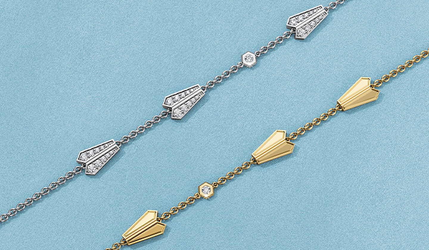 Birks Beekeeper yellow gold and diamond bracelets on a blue background.
